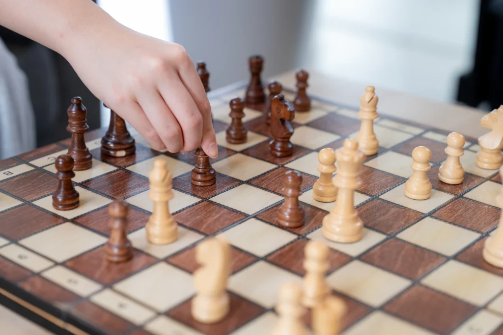 Boarders gather around a piano and a chess game in the common room.