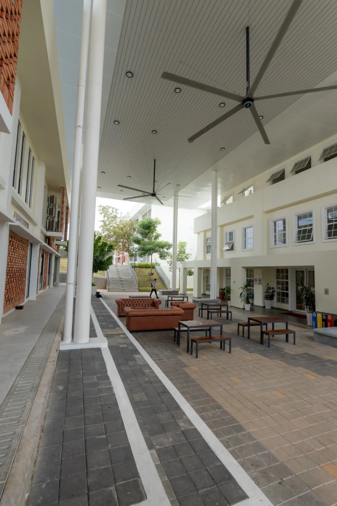 A covered outdoor seating area on the campus walkway.