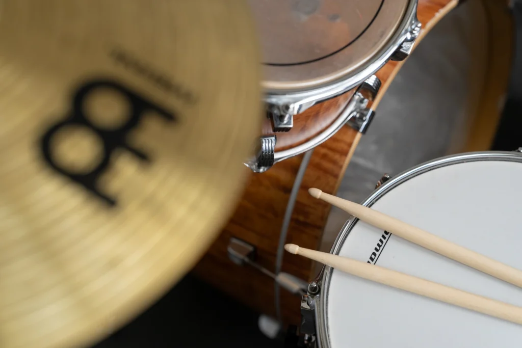 Drumsticks resting on a snare drum in one of the music practice rooms.