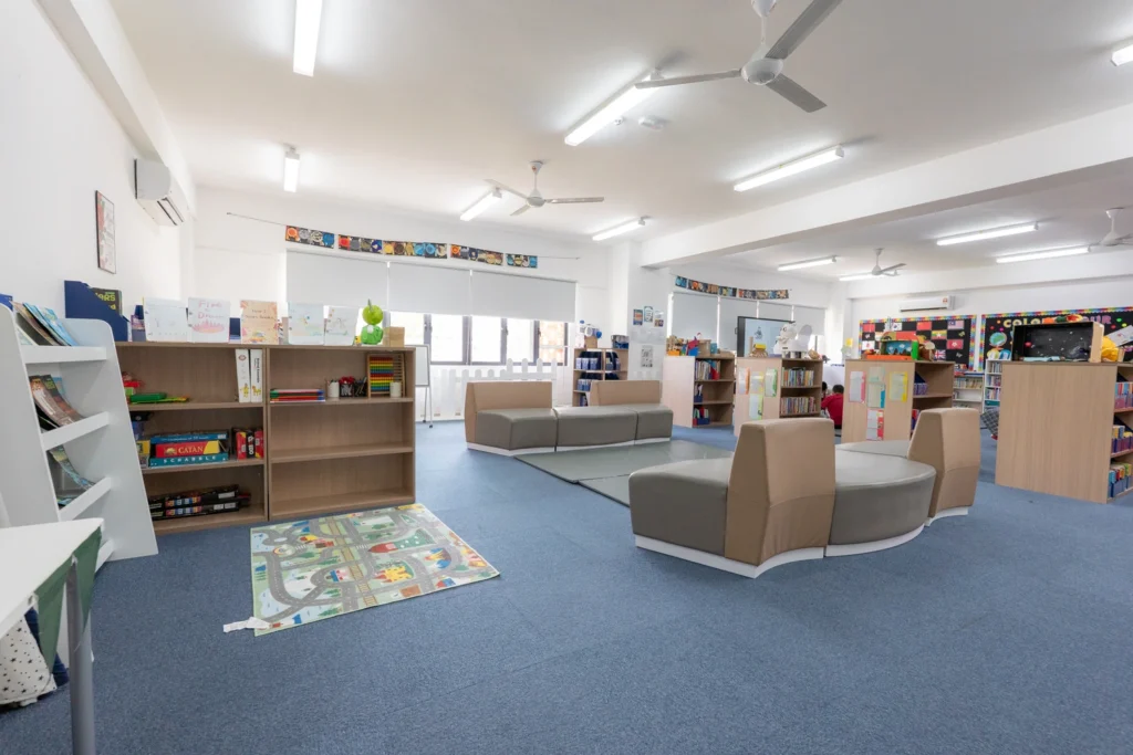 The Primary library with low shelving, soft seating and a reading area.